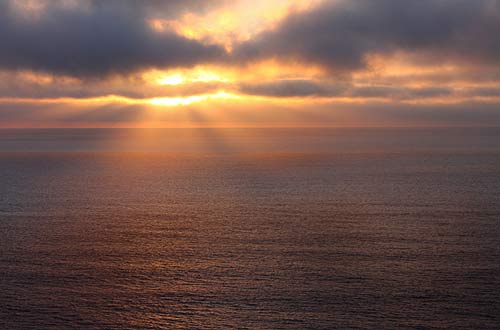 a gorgeous sunset erupts in front of Oregon Coast Beach Connection video and still cameras